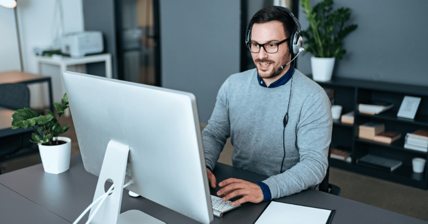 A person wearing headphones and using a computer
AI-generated content may be incorrect.