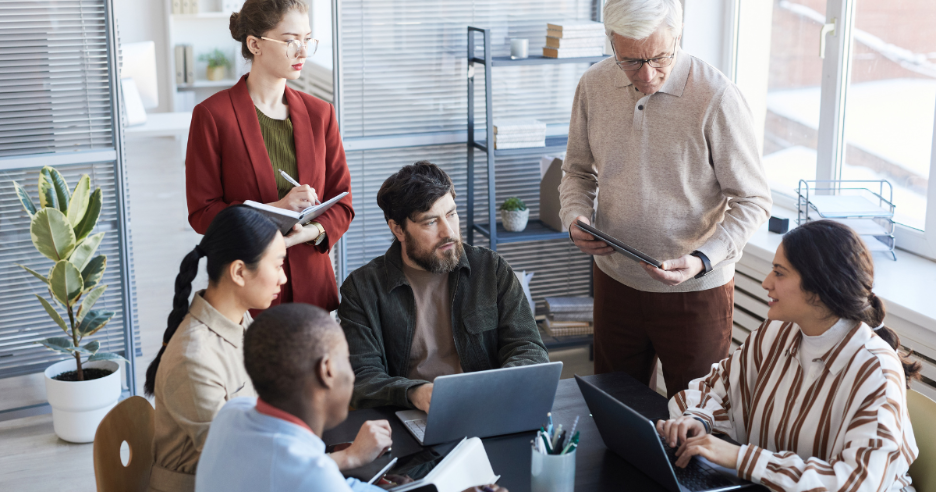 A group of people in a meeting
AI-generated content may be incorrect.