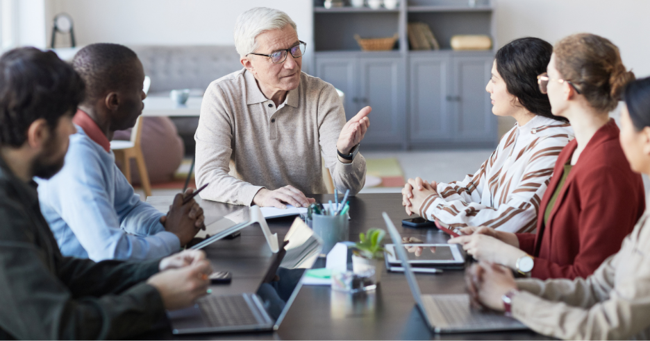 A group of people sitting around a table
AI-generated content may be incorrect.